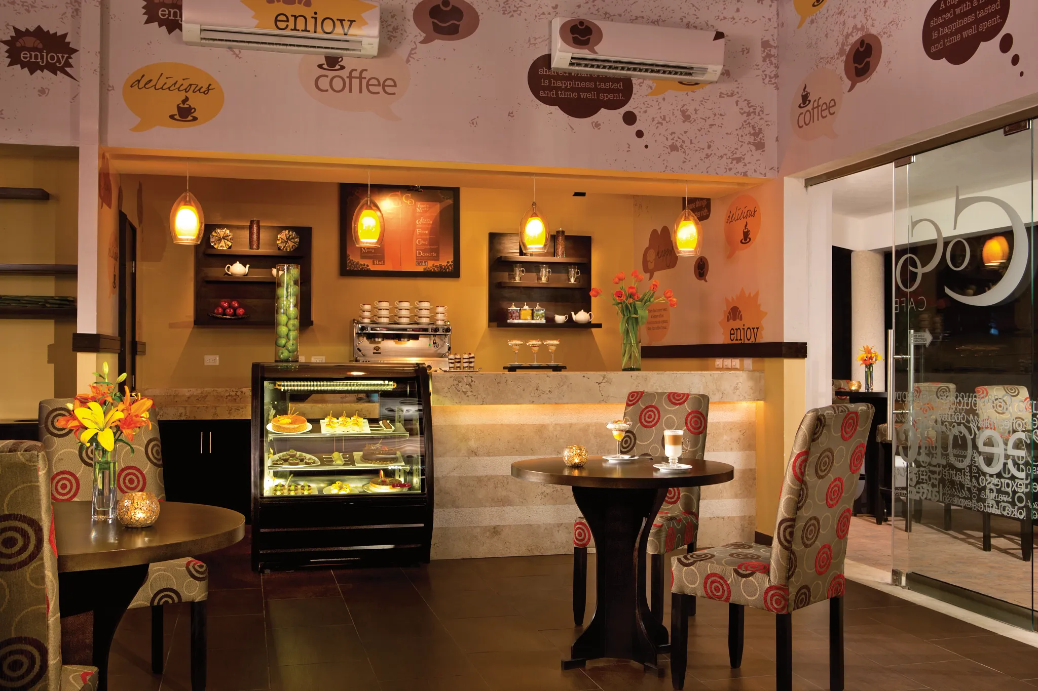 Coco Café at Secrets Aura Cozumel featuring a cozy coffee shop atmosphere, premium espresso drinks, and fresh pastries.