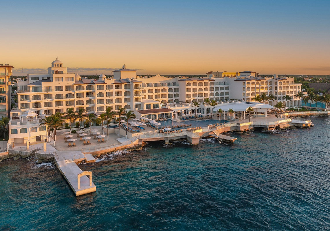 Cozumel Palace all-inclusive resort with oceanfront suites, infinity pools, and panoramic Caribbean Sea views.