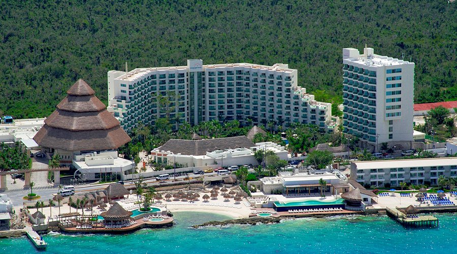 Grand Park Royal Cozumel all-inclusive family resort with beachfront pools, tropical gardens, and Caribbean Sea views.