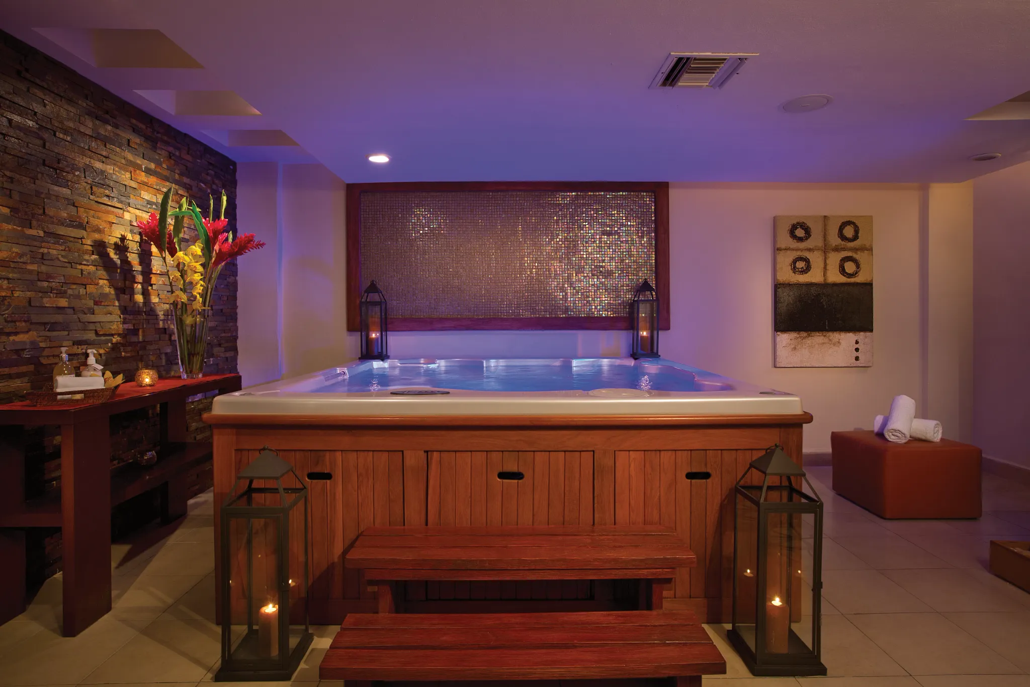 Indoor spa hydrotherapy circuit with cascading water features at Secrets Aura Cozumel.