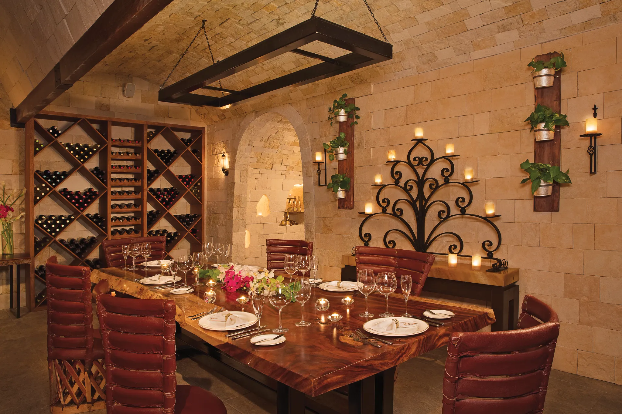 La Cava private dining at Secrets Aura Cozumel featuring an elegant wine cellar, intimate table setting, and premium wine selections.