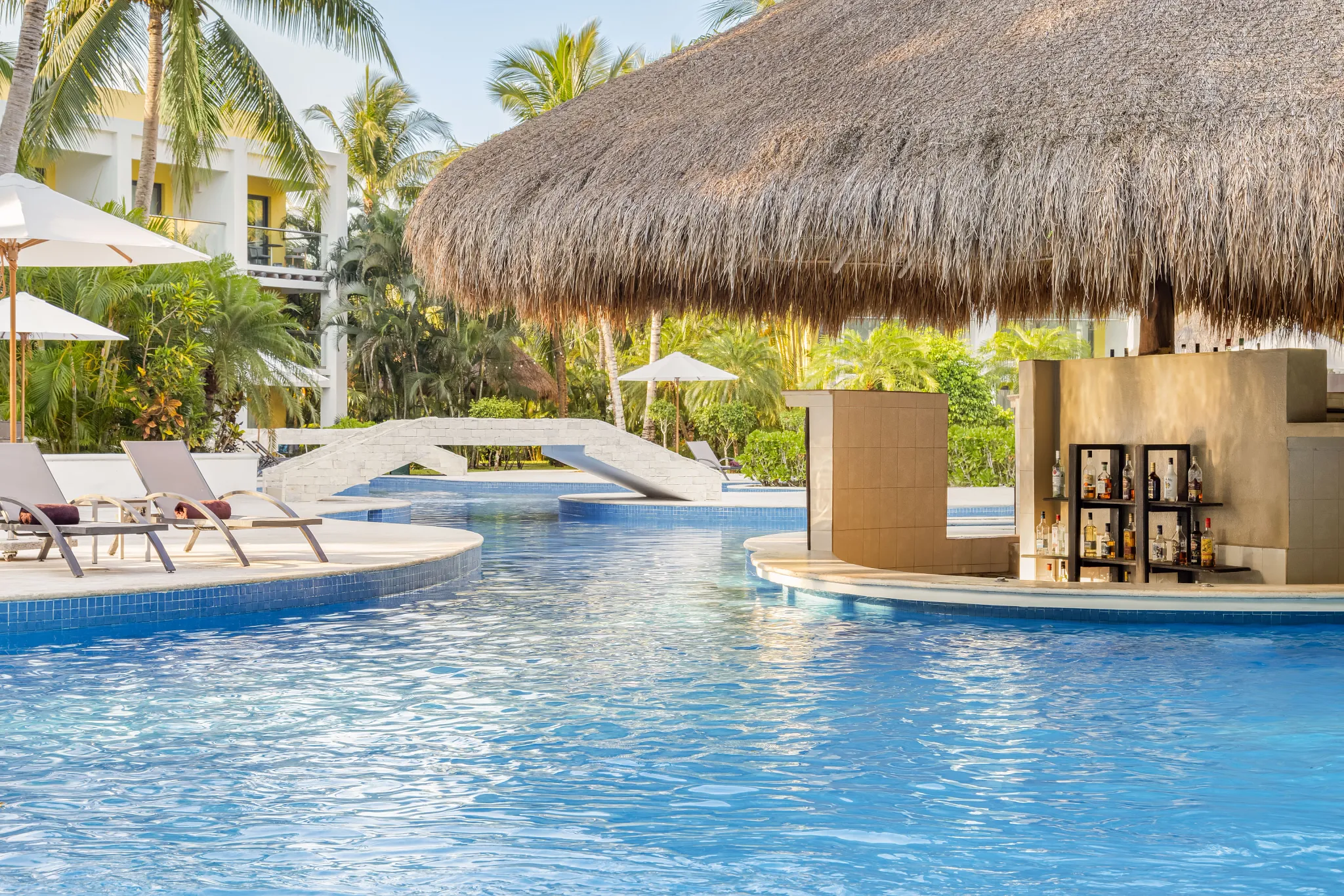 Manatees Swim-Up Bar at Secrets Aura Cozumel featuring a relaxed poolside setting, tropical cocktails, and refreshing drinks in a beach-casual atmosphere.