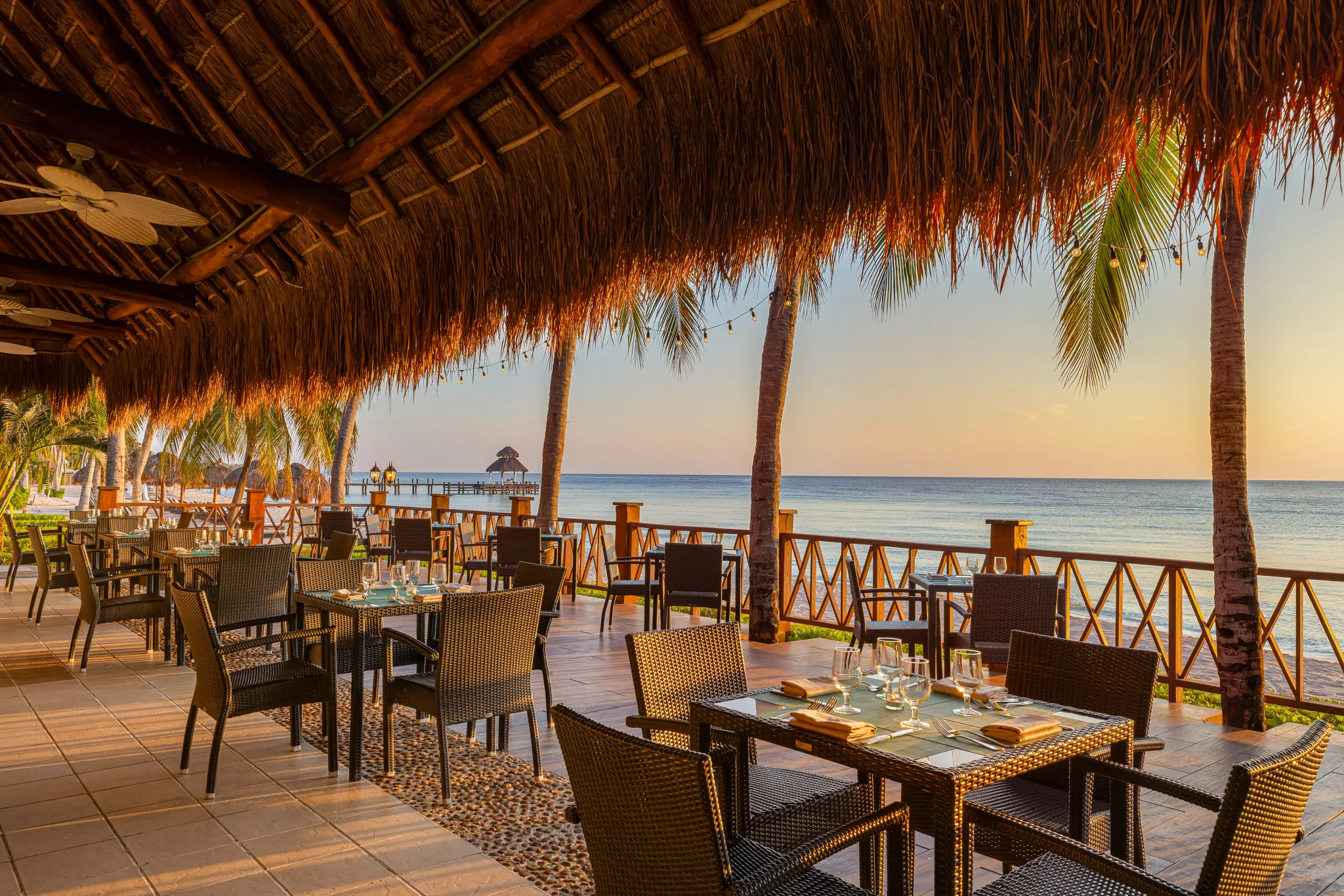 Market Café buffet restaurant at Secrets Aura Cozumel featuring oceanfront dining, international cuisine stations, and a vibrant open-air setting.