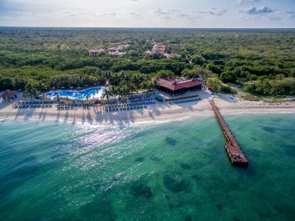 Occidental Cozumel all-inclusive resort with tropical architecture, pools, and lush gardens near the beach.