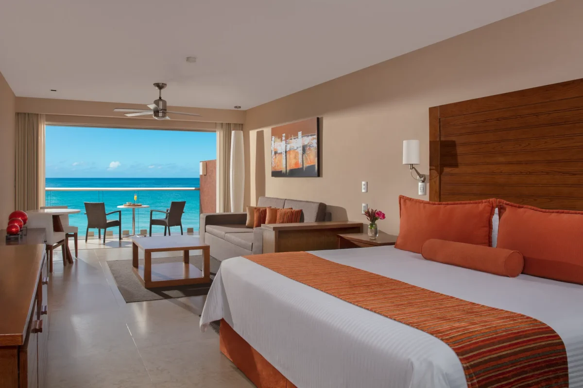 Preferred Club Junior Suite Ocean Front with king bed and private balcony overlooking the ocean at Secrets Aura Cozumel.
