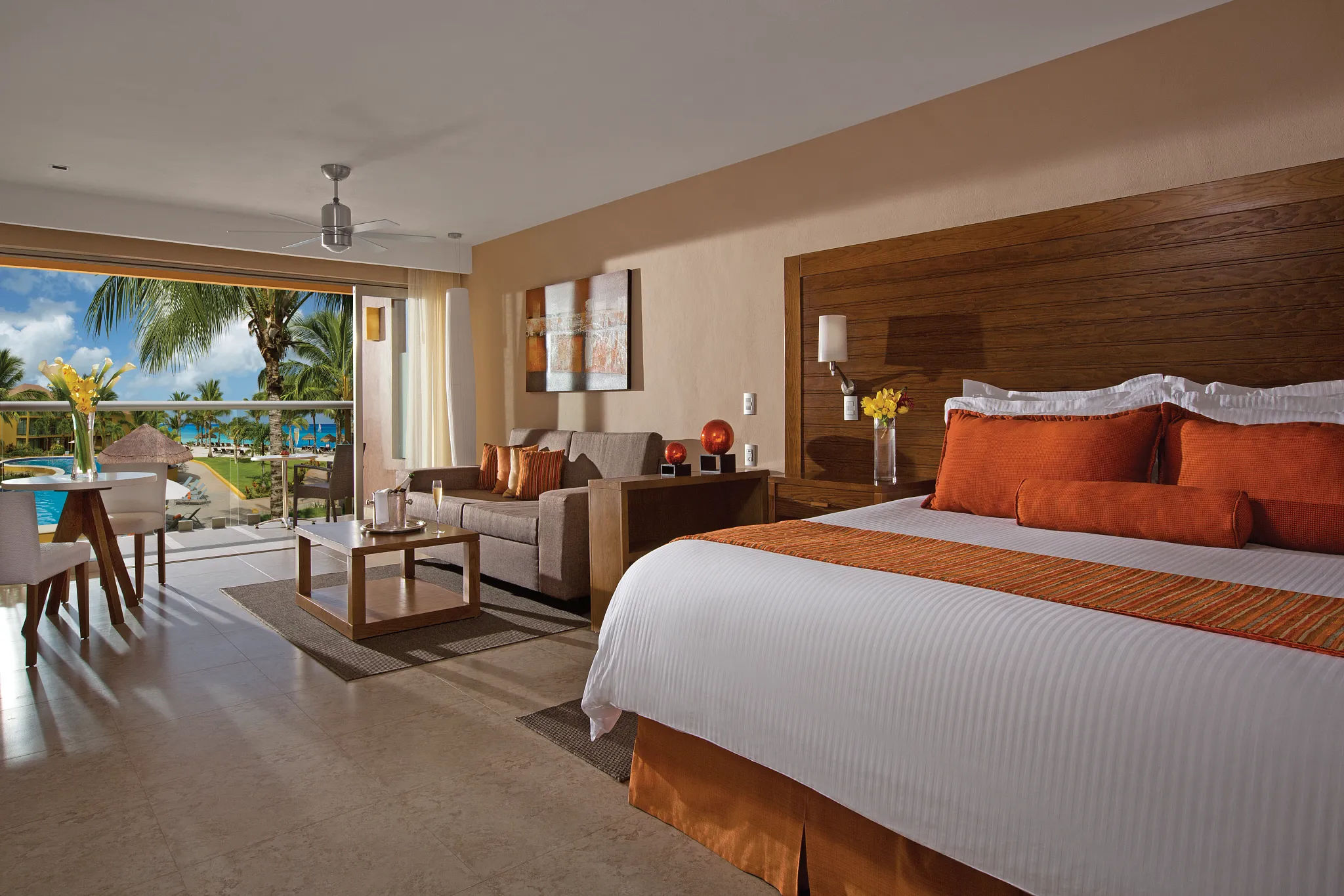 Preferred Club Junior Suite Ocean View with king bed, seating area, and balcony overlooking the ocean at Secrets Aura Cozumel.