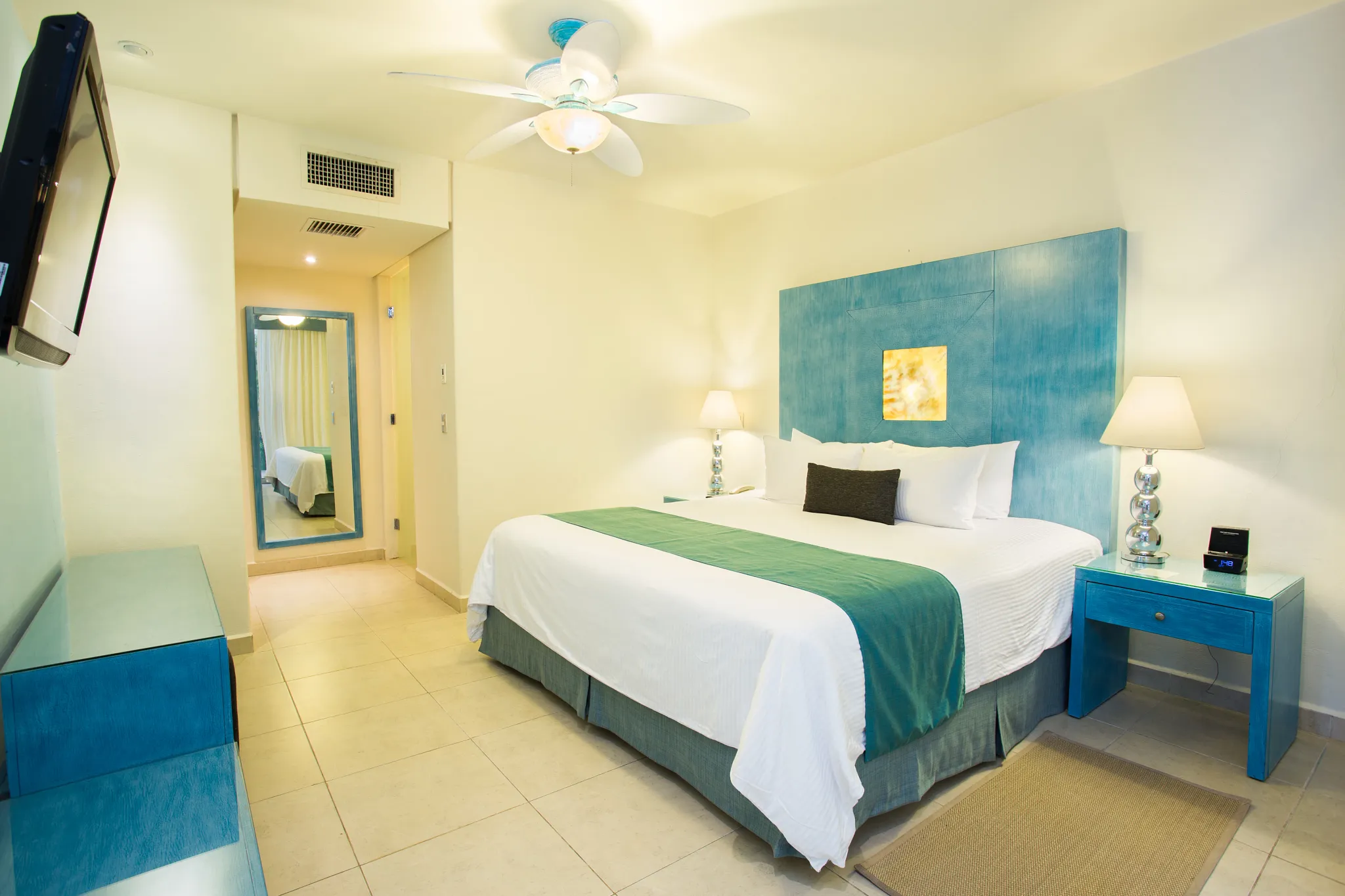 Preferred Club Junior Suite Swim-Up Beach Front bedroom with king bed and modern decor at Secrets Aura Cozumel.