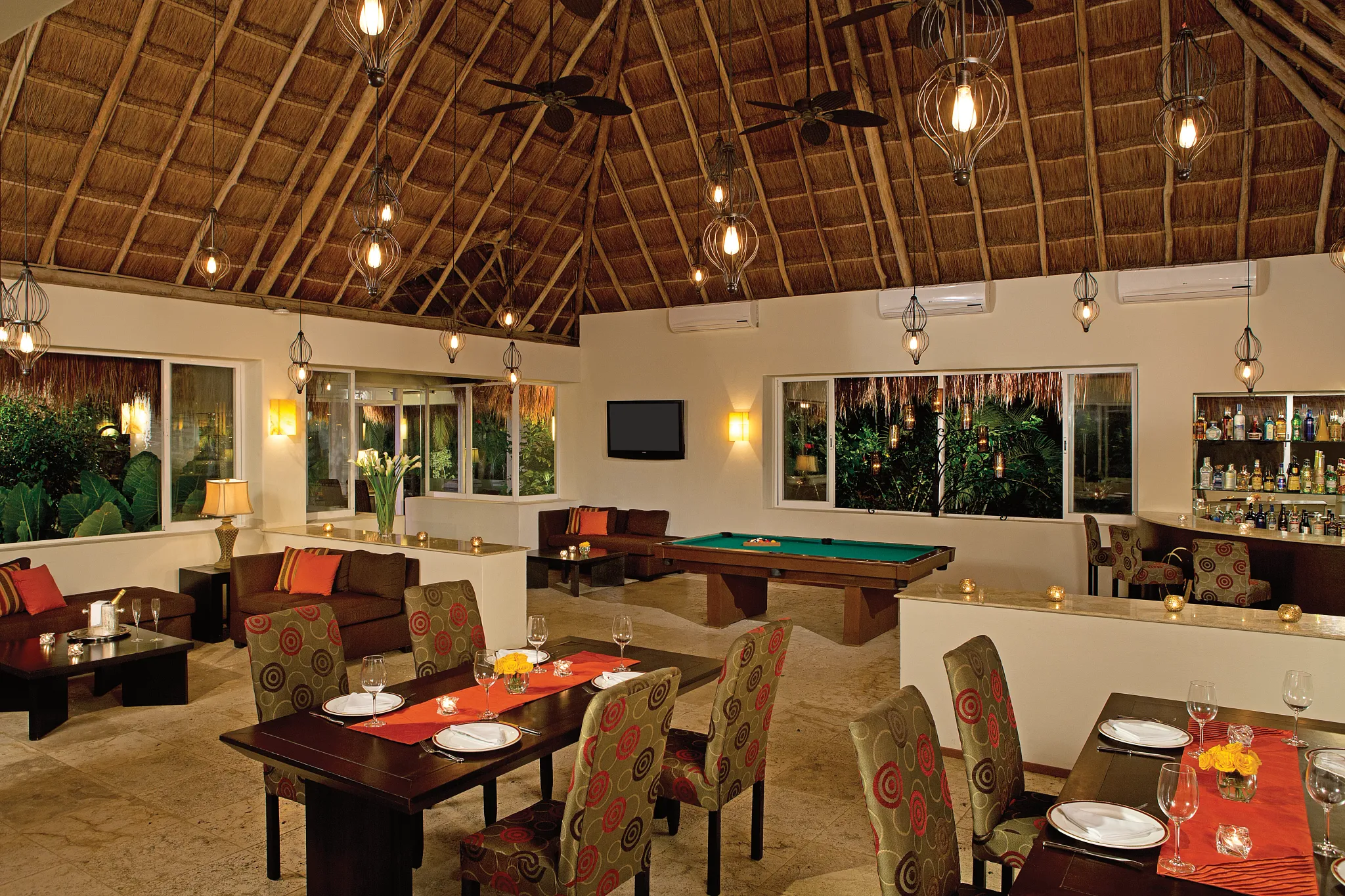 Indoor lounge with billiards table, bar, and seating area at Secrets Aura Cozumel, perfect for evening entertainment.