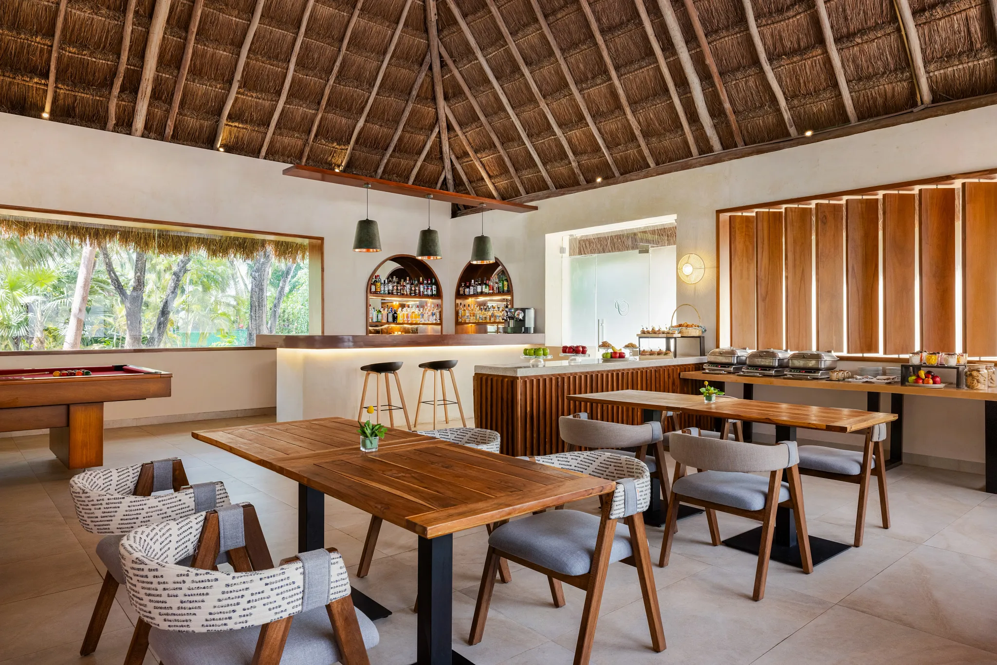 Preferred Club lounge dining area with buffet setup and wooden decor at Secrets Aura Cozumel.