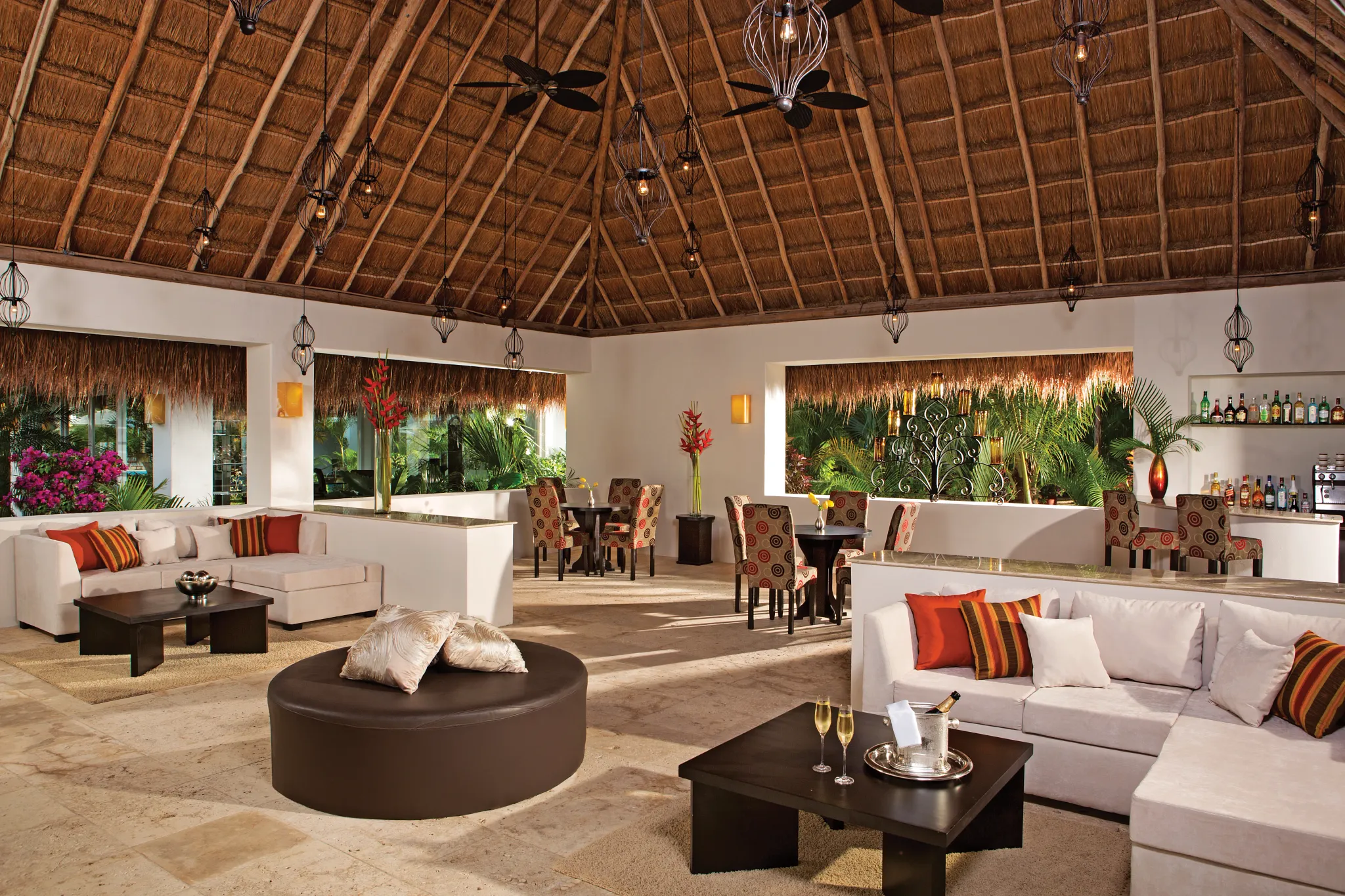 Elegant Preferred Club lounge with comfortable seating, bar, and tropical decor at Secrets Aura Cozumel.