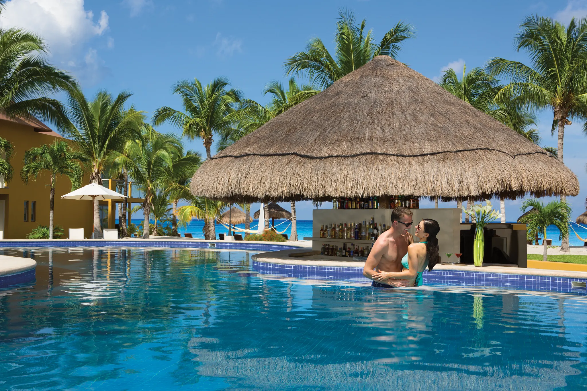 Preferred Club Swim-Up Bar at Secrets Aura Cozumel featuring a private poolside bar, refreshing cocktails, and relaxed beach-casual atmosphere.