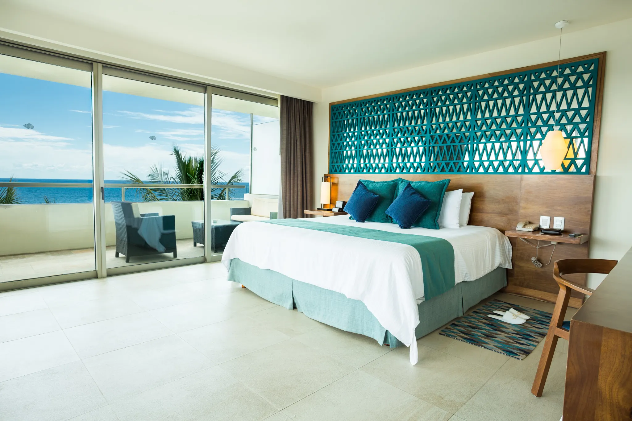 Rooftop plunge pool overlooking resort and ocean at Secrets Aura Cozumel.