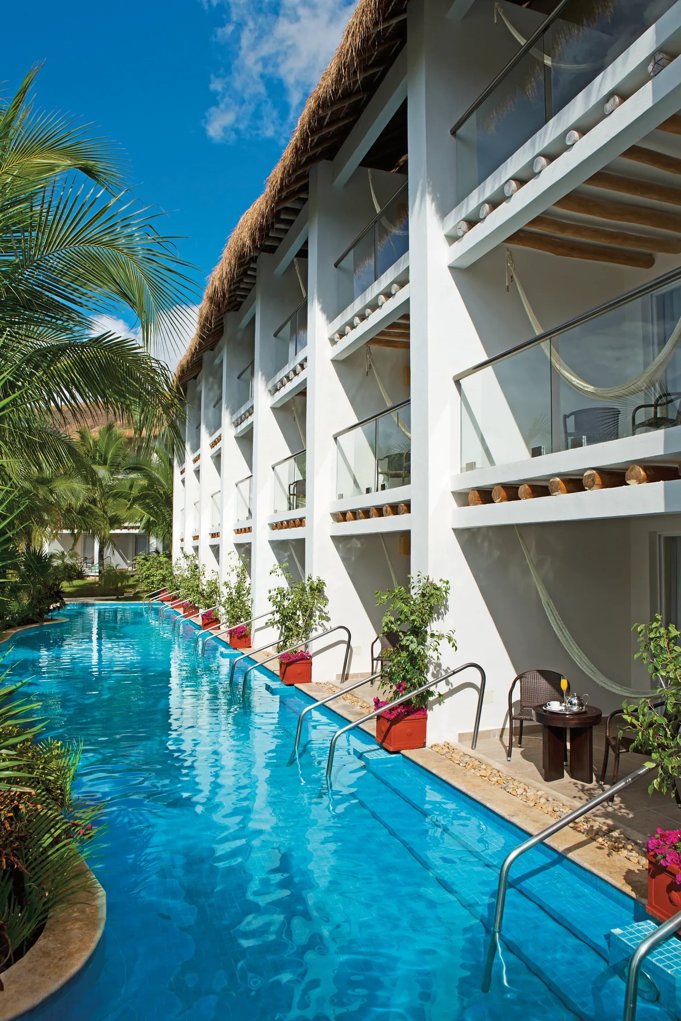 out suites at Secrets Aura Cozumel with private pool access, hammocks, and tropical landscaping.