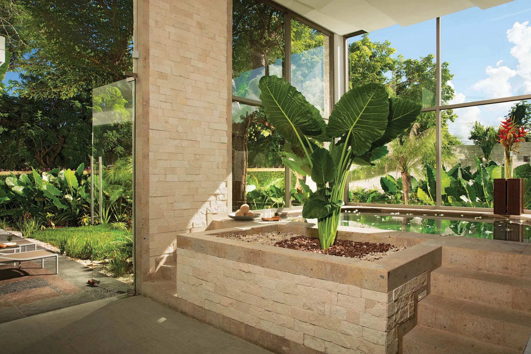 Indoor spa whirlpool surrounded by tropical greenery at Secrets Aura Cozumel, offering a peaceful hydrotherapy experience.